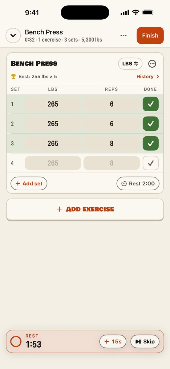 Brolic&rsquo;s workout logger: bench press sets of 265 lbs ticked off, your best set shown above them, and a floating rest timer at the bottom.