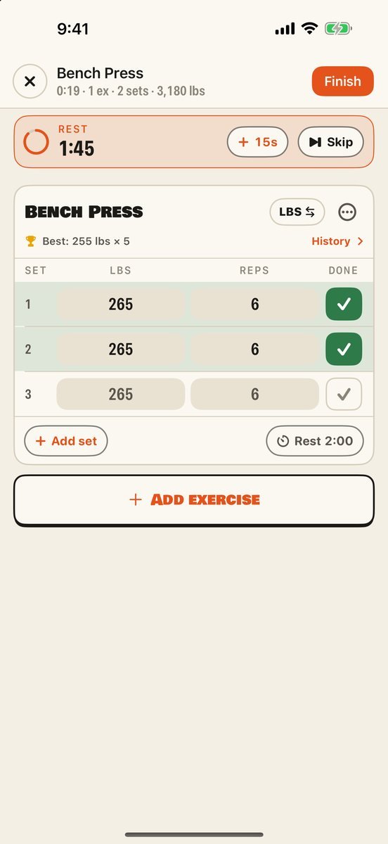 Brolic&rsquo;s workout logger: two bench press sets of 265 lbs for 6 ticked off, the user&rsquo;s best shown above, and a rest timer running at the top.