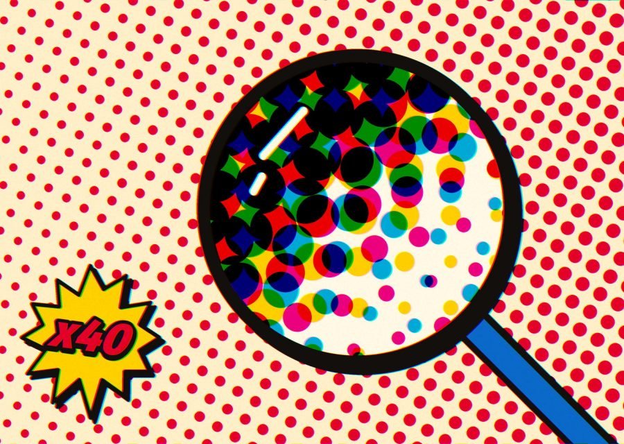 A magnifying glass over red Ben-Day dots, showing cyan, magenta and yellow dots overlapping
